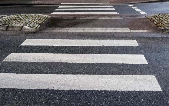 White painted pedestrian zebra crossing on a road in Europe