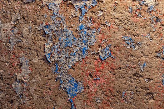 shabby peeled white, blue and red paint layers on concrete surface - flat background and texture.