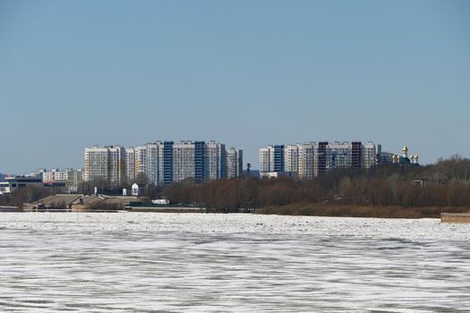 Spring ice on the river. Panorama is a city by the river. High quality photo