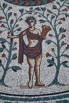 Detail of the encircling scroll of the Roman style mosaic at the entrance of the Roman Gardens in Chester, England.