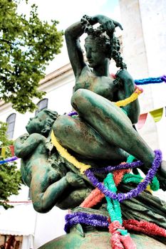 Lisbon, Portugal- June 4, 2018: Rusty statue decorated with garlands for Saint Anthony festivities in Lisbon