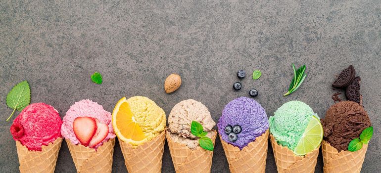 Flat lay ice cream cones collection on dark stone background . Blank crispy ice cream cone with copy space for sweets menu design.