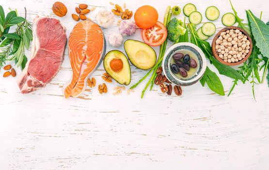 Ketogenic low carbs diet concept. Ingredients for healthy foods selection on white wooden background. Balanced healthy ingredients of unsaturated fats for the heart and blood vessels.