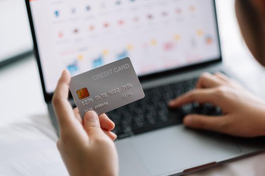 woman shopping online with credit card. woman holding credit card and using laptop. Online shopping concept.