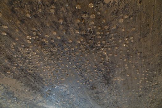 condensed water drops on the basement ceiling - close-up with selective focus.