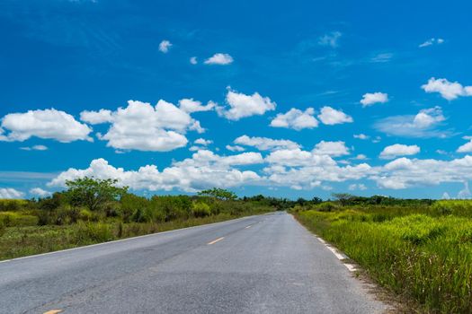Small country road or street with blue sky background.