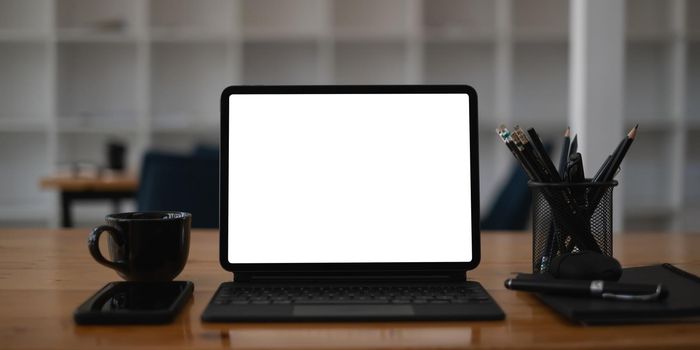 White blank screen tablet on modern working desk