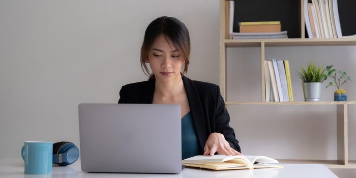 Work from home concept, Asian business woman using laptop, communicates on internet with customer in home