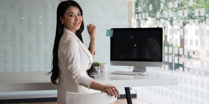 Portrait of Asian businesswoman smile and sitting at her office