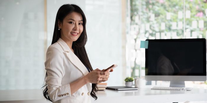 Portrait of businesswoman with mobile phone for video conference with partners