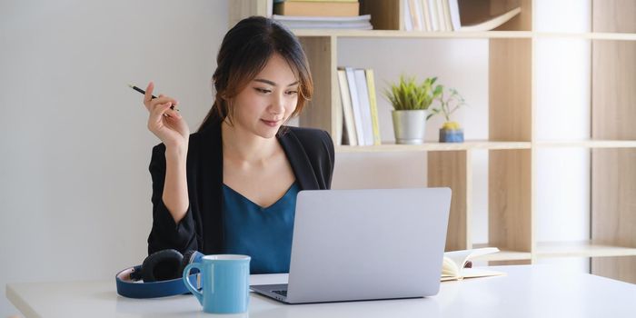 Businesswoman in having a video call on laptop while discussion with business partner during work from home