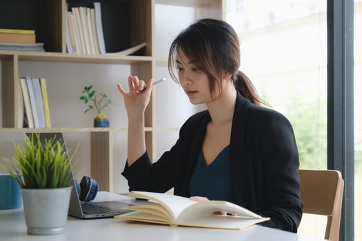 Homeschool. Asian girl student with pen and notebook for learning virtual internet online class. covid pandemic