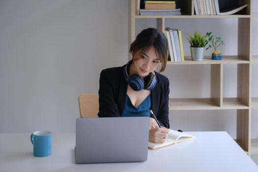 Homeschool. Asian girl student with pen and notebook for learning virtual internet online class. covid pandemic