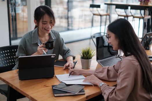 Business woman and partners in smart casual wear discussing business while sitting in the home office. Confident and successful team