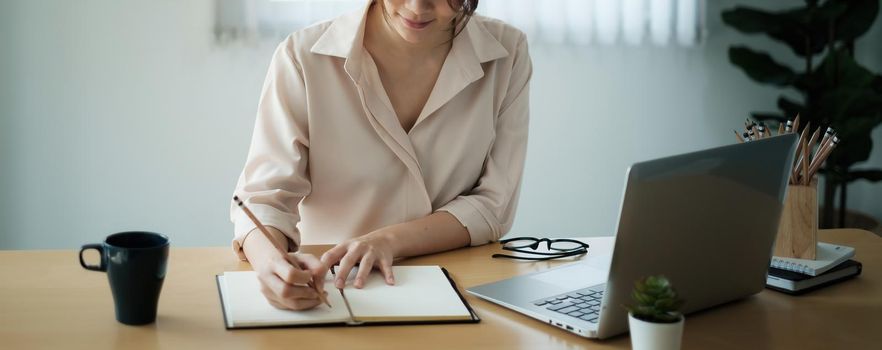 Video conference, Online meeting video call, close up of business woman looking at laptop computer screen working or watching webinar on laptop in workplace