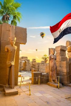 Ruined statues in Karnak temple at beautiful sunrise