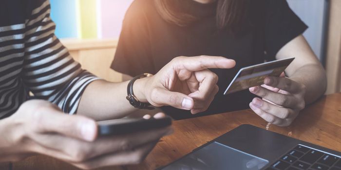 Mobile banking. Man and Woman using online banking with credit card on mobile phone. Digital and internet payments shopping on network