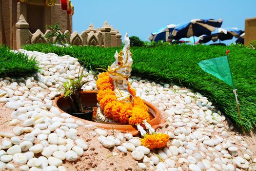 sand pagoda and naga in Songkran festival represents In order to take the sand scraps attached to the feet from the temple to return the temple in the shape of a sand pagoda