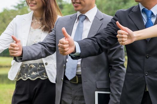 Business team showing hand of success symbol