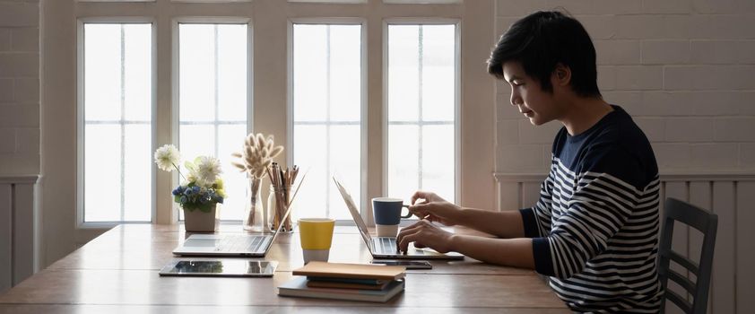 Asian businessman Fund managers analyzing results of research Investment stock market by laptop computer