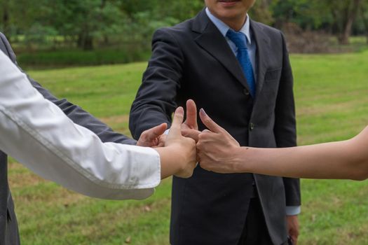 Business team showing hand of success symbol