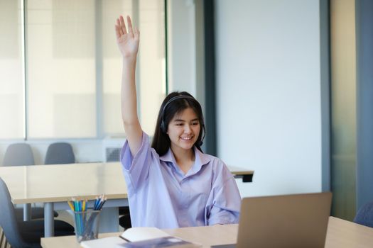 Social distancing.stay home. New normal.Covid-19 coronavirus concept. Children raise hand up response for answer the question in the online class by laptop computer