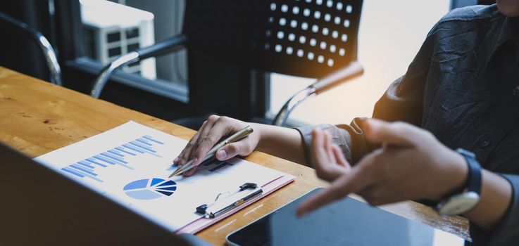 Close up Business woman using calculator for do math finance on wooden desk in office. tax, accounting, statistics and analytic research concept. top view