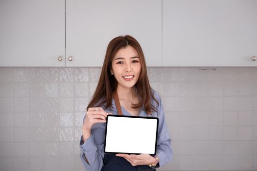 Businesswoman holding tablet blank screen with smile