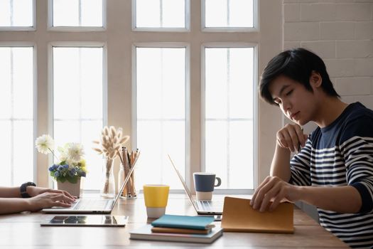 Asian businessman Fund managers analyzing results of research Investment stock market by laptop computer