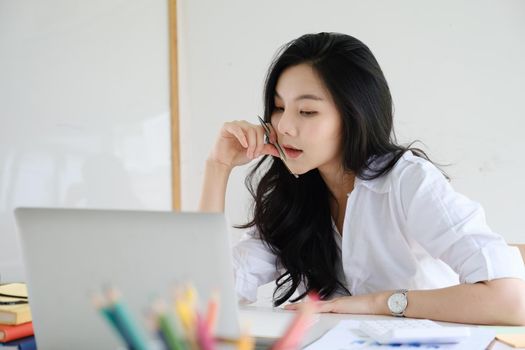 Portrait of Asian Business woman working from home. Accounting concept
