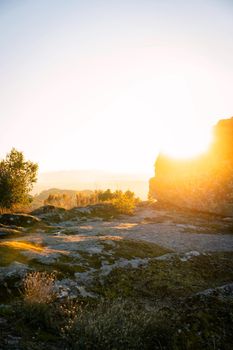 Sortelha nature mountain landscape with sun flare on a boulder, in Portugal