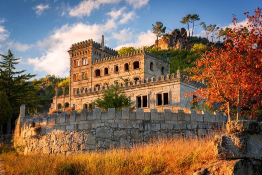 Abandoned ruin building of Termas Radium Hotel Serra da Pena in Sortelha with beautoful colorful trees at sunset, Portugal