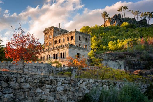 Abandoned ruin building of Termas Radium Hotel Serra da Pena in Sortelha with beautoful colorful trees at sunset, Portugal