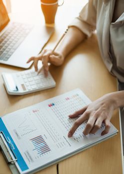 Business woman using a calculator to calculate working on desk in home office. Consultant,Financial Consultant,Financial advisor and accounting concept