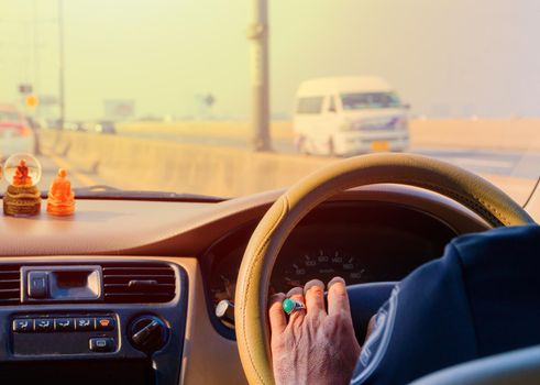 hand of man driving car travel on road Traffic jam and sunlight