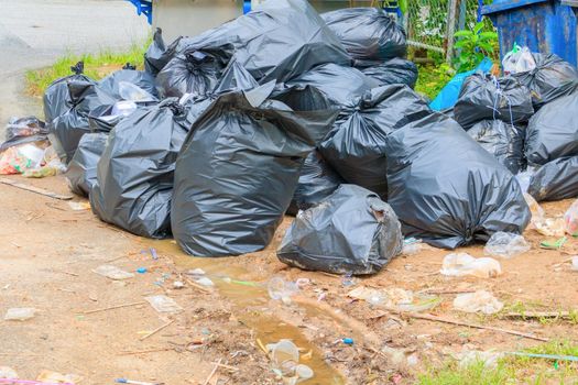 Pile garbage black bag plastic roadside in the city
