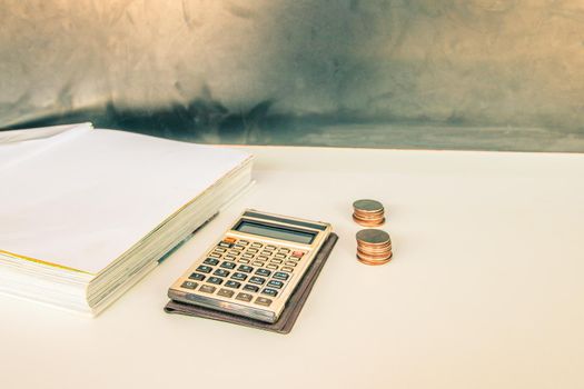 coin money and calculator old, book over white and black background with copy space add text. color vintage style tone