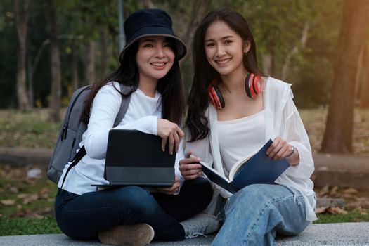 Friends or Family concept. Two Female using maps on tablet while travel