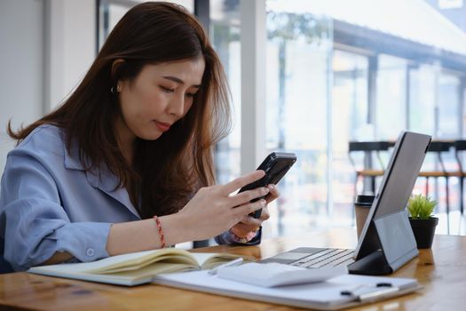 Portrait of business woman discussing to his partners about new product while talking with mobile phone in home office