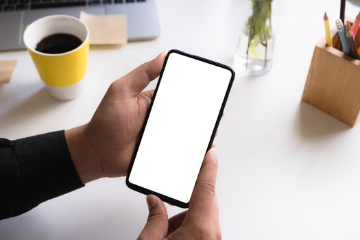 Businessman showing smartphone with empty screen