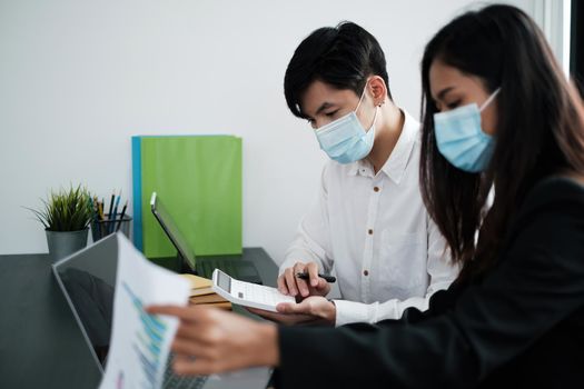 Businessman and team wear mask and try to explain about his work at home office