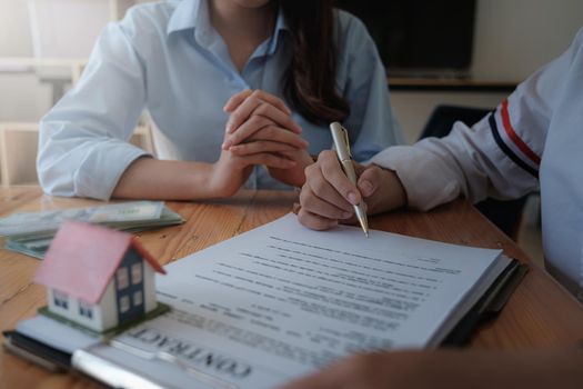 Businesswoman puts signature on contract at business meeting and sign in contract with business partners
