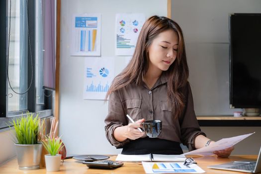 Portrait of business woman and smiling using video call on laptop computer with her parents. Quarantine and work from home concept