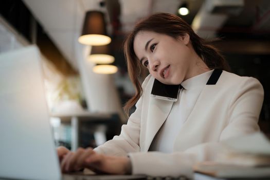 Business coffee shop owner talking with customer and telling cafe is back to open now and safe after covid-19 have vaccine. Female take the phone and make ads on laptop