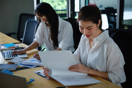 Two of Young business female working together and partners talking with customer