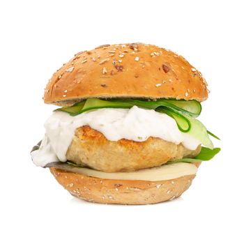 Fishburger fish burger with cod cutlet cucumber lettuce goat cheese dzatziki tartarus sauce and grain cereal bread isolated on white background