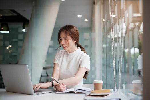 Freelance woman busy working on laptop computer at home office. Business owner check list selling order from online shop application by laptop computer