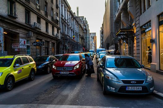 Car traffic at rush hour in downtown area of the city. Car pollution, traffic jam in the morning and evening in the capital city of Bucharest, Romania, 2021