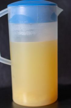 Orange juice in pitcher. Isolated on white background.