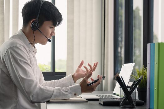Young man student wear wireless headphone study online. She learn language listen lecture watch webinar write notes look at laptop, distant education